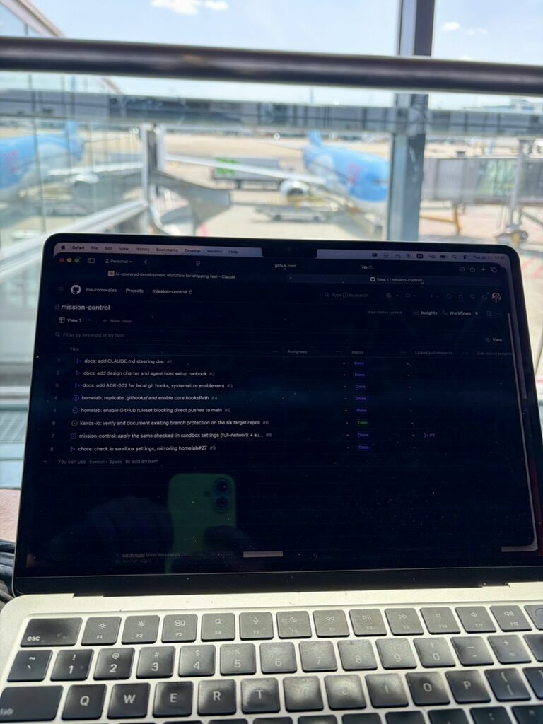 The mission-control project board open on a laptop at an airport gate